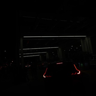 Glowing Taillights Queue at Night Festival Entrance