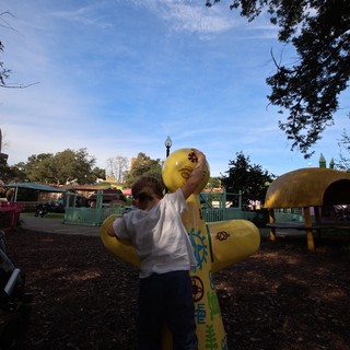 Child on Yellow Duck Spring Rider at Fantasyland Playground