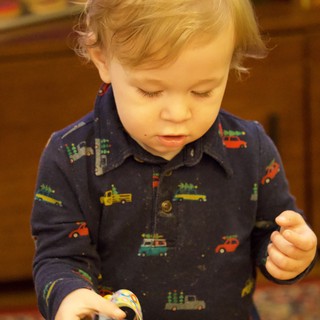 Toddler Focused on Christmas Activity in Vehicle Pajamas