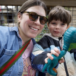 Mother and Son with Dinosaur Toy at Zoo