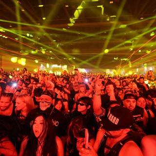 Massive Crowd Electrified Under Laser Light Show
