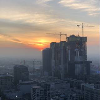 Urban Sunset with Construction Cranes