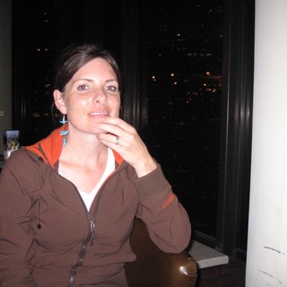 Thoughtful Woman at Night with City Views