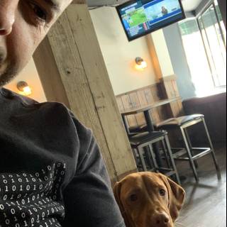 Man and Dog: A Comfortable Duo at the Bar