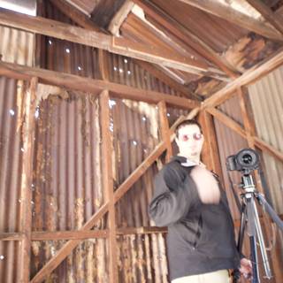 Man with Tripod Captures Wood Barn