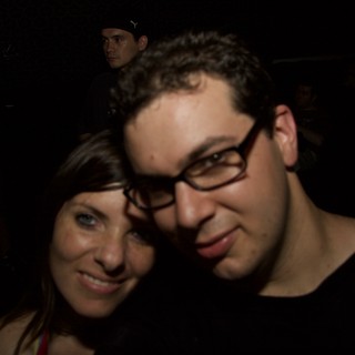 Two Friends Smiling Together at Nighttime Event