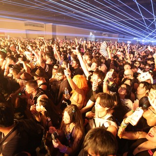 Massive Indoor Rave Crowd Under Electric Laser Light Show