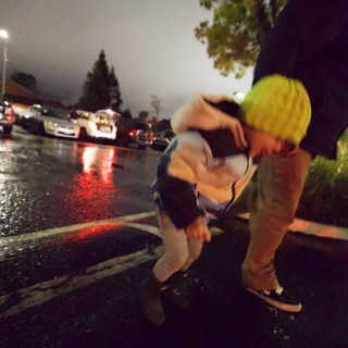 Rescue Worker Assists Person During Rainy Night Emergency