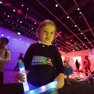 Young Child at Baby Rave with Glowing Light Toy