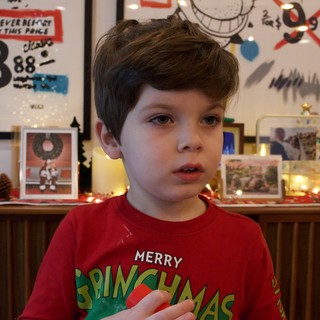 Young Child in Festive Grinchmas Sweater at Christmas