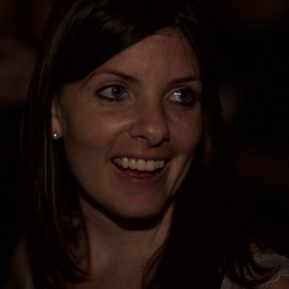 Candid Smile in the Darkness of a Dimly Lit Venue
