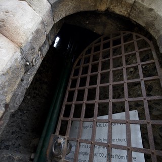 Ancient Stone Archway with Rusted Iron Gate