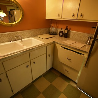 Retro Kitchen Corner with Orange Walls and Checkered Floor