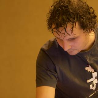 Curly-haired man sporting a T-shirt