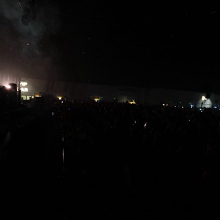 Massive Crowd Engulfed in Festival Fog and Darkness