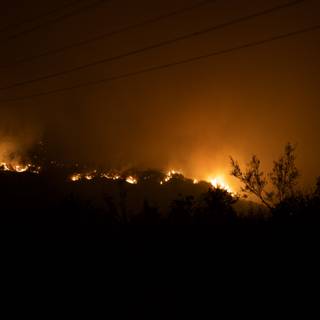 Flames Illuminate Night Sky Amid Station Fire