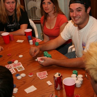 Friends Gathered Around Table for Poker Night