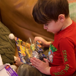 Child Opening LEGO Gift on Christmas Morning