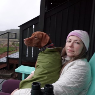 Woman and Dog Relaxing on Mountain Deck