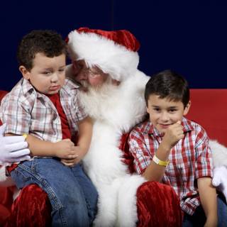 Santa Claus and Two Boys on a Festive Red Couch