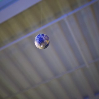 Earth Marble Suspended in Mid-Air Reflection