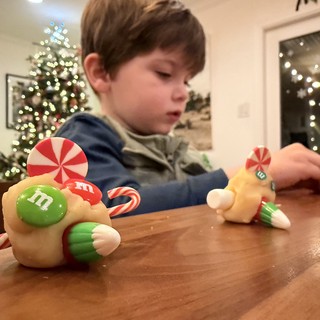 Child Decorating Gingerbread House on Christmas Eve