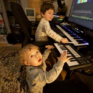 Two Young Children Playing Music Keyboard in Home Studio