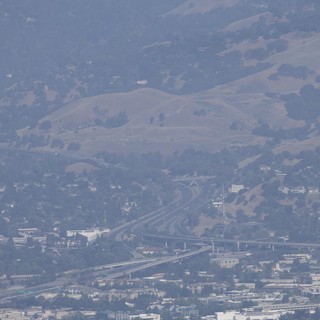 Hazy Interstate Interchange Beneath California's Rolling Hills