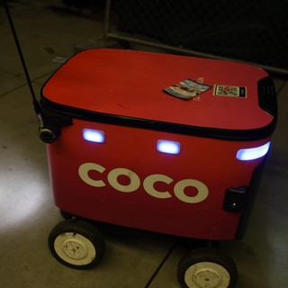 Coco Delivery Robot Navigating Nighttime Festival Grounds