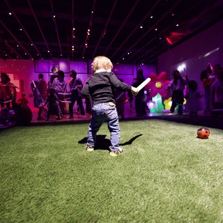 Toddler Playing at Baby Rave in Purple Neon Museum