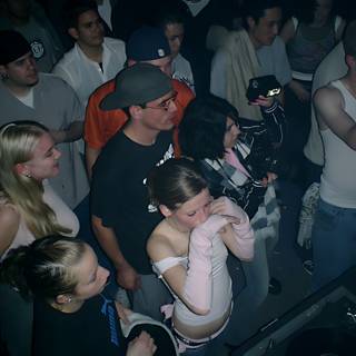 Nightclub Crowd Gathers around DJ