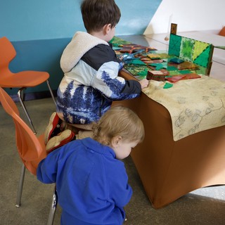 Children Exploring Interactive Exhibit at Play Space