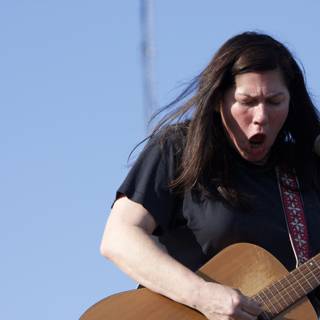 Kim Deal strums her acoustic guitar at Coachella 2008