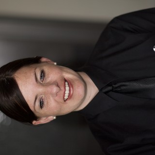 Smiling Woman in Black Uniform Portrait