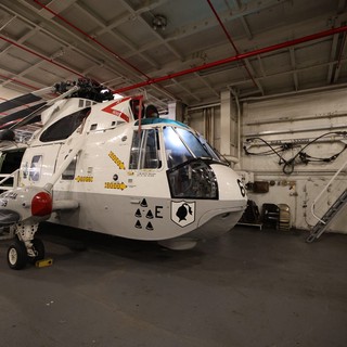 Military Helicopter in Aircraft Carrier Hangar Bay