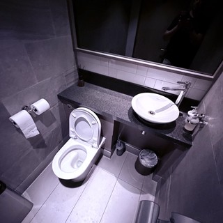 Modern Minimalist Bathroom with Dark Granite Countertops