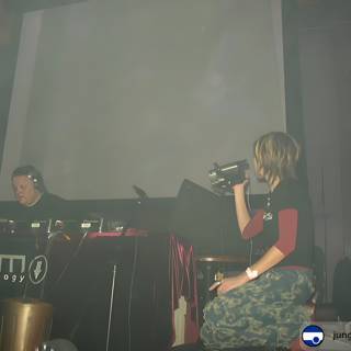 Woman enjoys musical performance by the DJ on stage