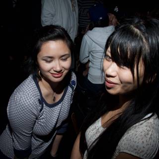 Two Smiling Women at a Night Club Party