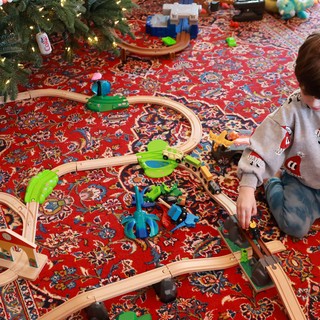 Child Playing with Wooden Train Set on Christmas
