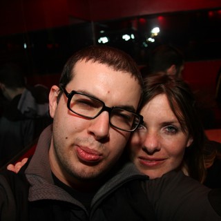 Friends Posing Together at a Dimly Lit Nightclub