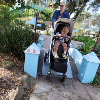 Parent and Child Crossing Miniature Bridge at Fantasyland