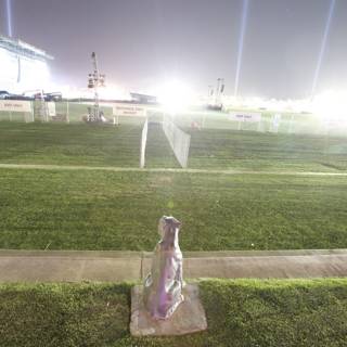 Bottle Statue on a Grassy Field