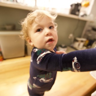 Curious Toddler in Christmas Pajamas Looking Up