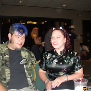 Blue-haired couple enjoying a night out at a military-themed bar