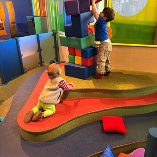 Children Building Tower with Oversized Foam Blocks