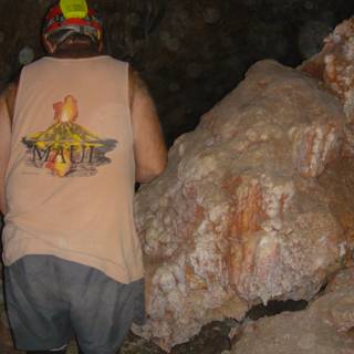Man Explores Cave in T-Shirt and Hardhat