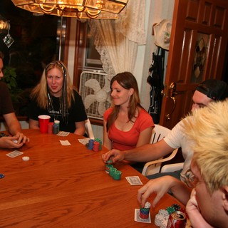 Friends Gathered Around Table for Home Poker Night