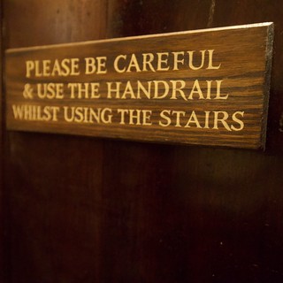 Historic Wooden Staircase Safety Sign in Old Building