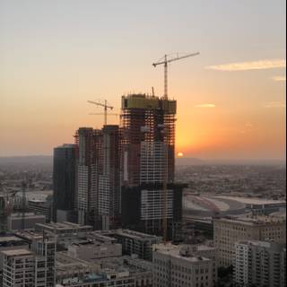 Urban Sunset over High-Rise Construction Site