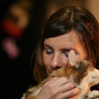 Woman Tenderly Nuzzles Orange Tabby Kitten